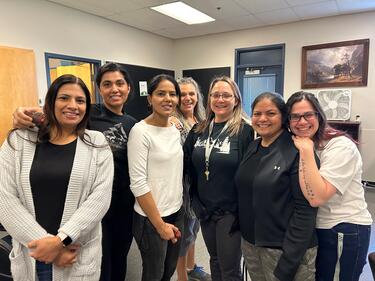 Group of Support Staff gathered together smiling