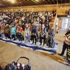 Indigenous Role Models stand on the blankets in the longhouse